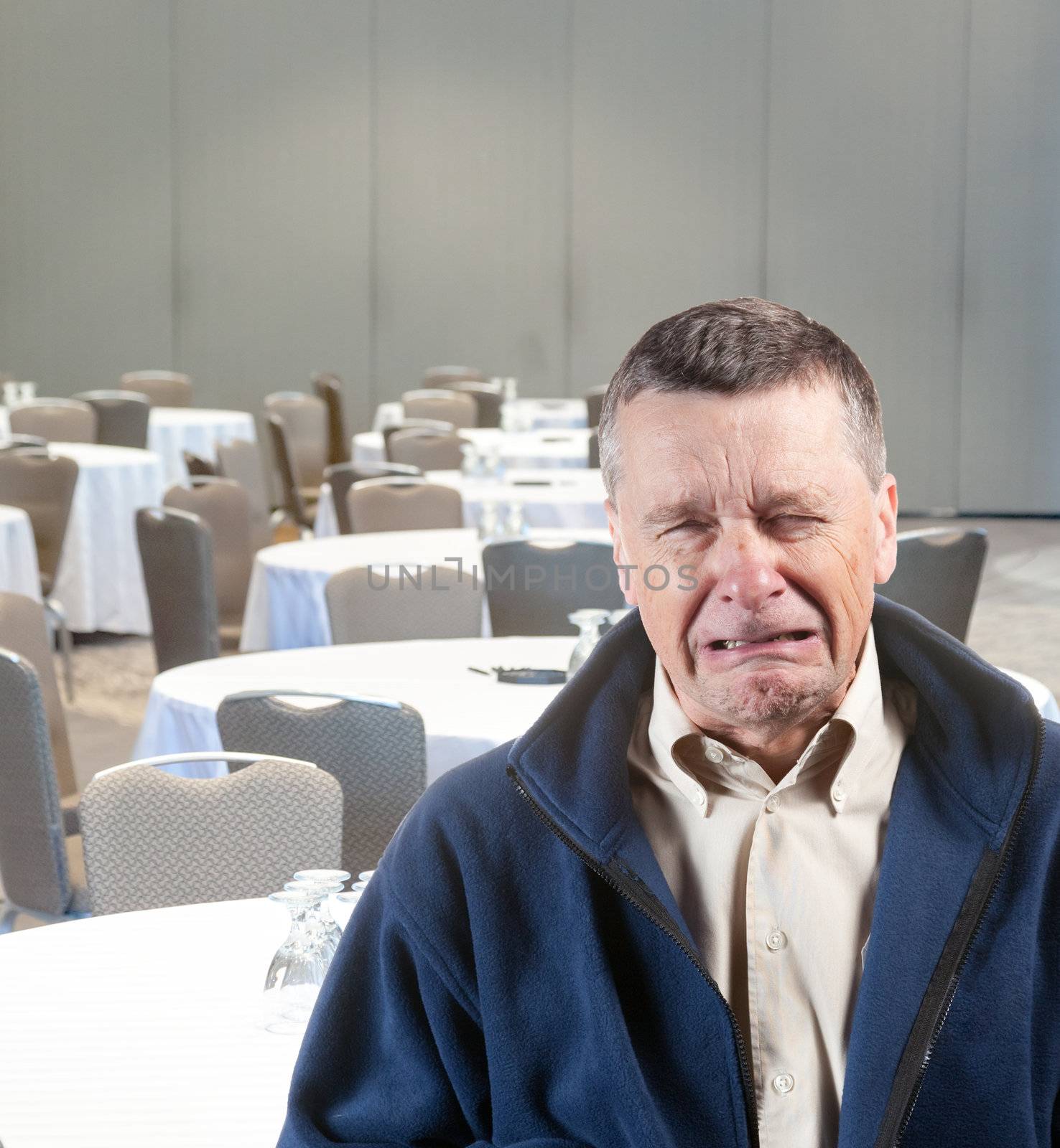 Senior male weeping in empty meeting room workplace harassment