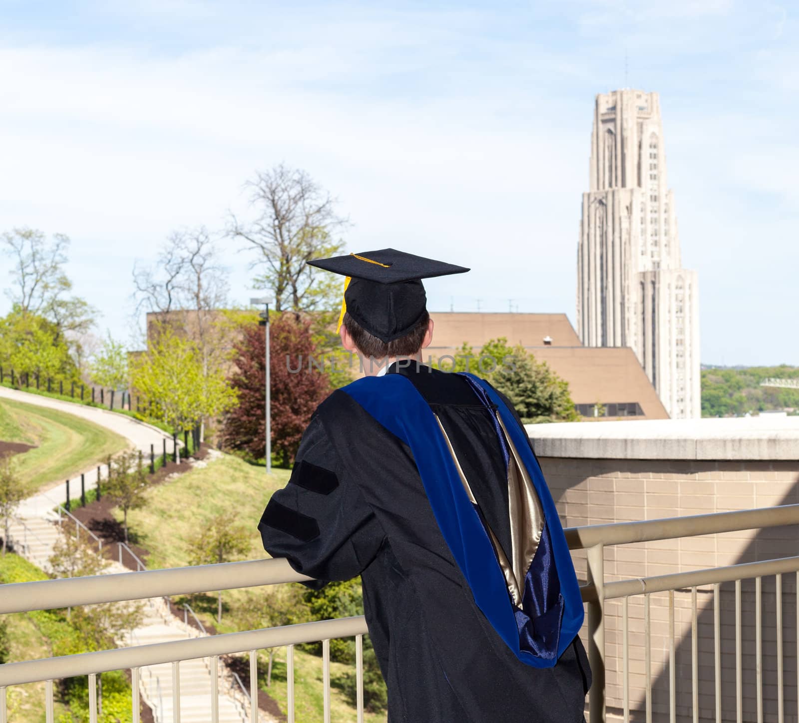 Doctoral graduate looking toward Cathedral of Learning at University of Pittsburgh