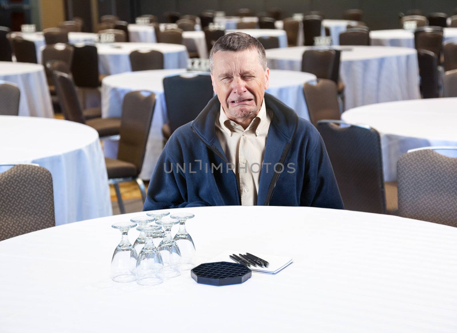 Man crying in empty conference room by steheap
