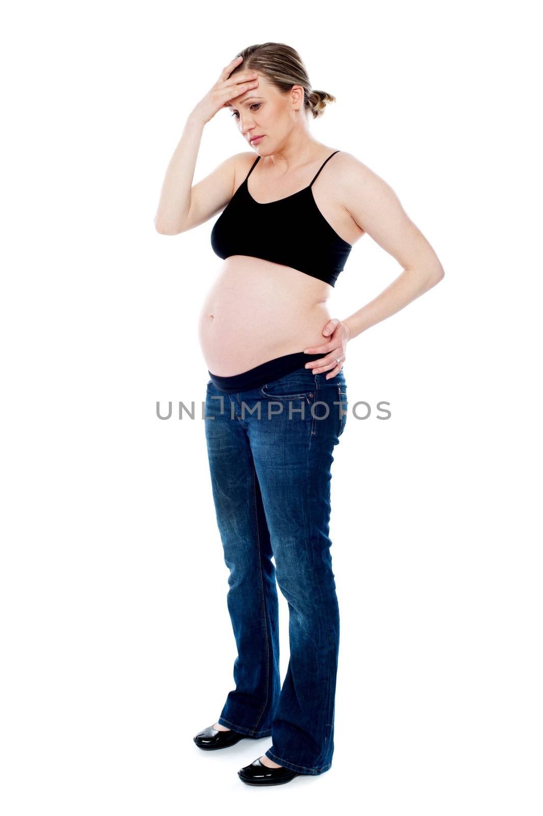 Pregnant woman having headache by stockyimages