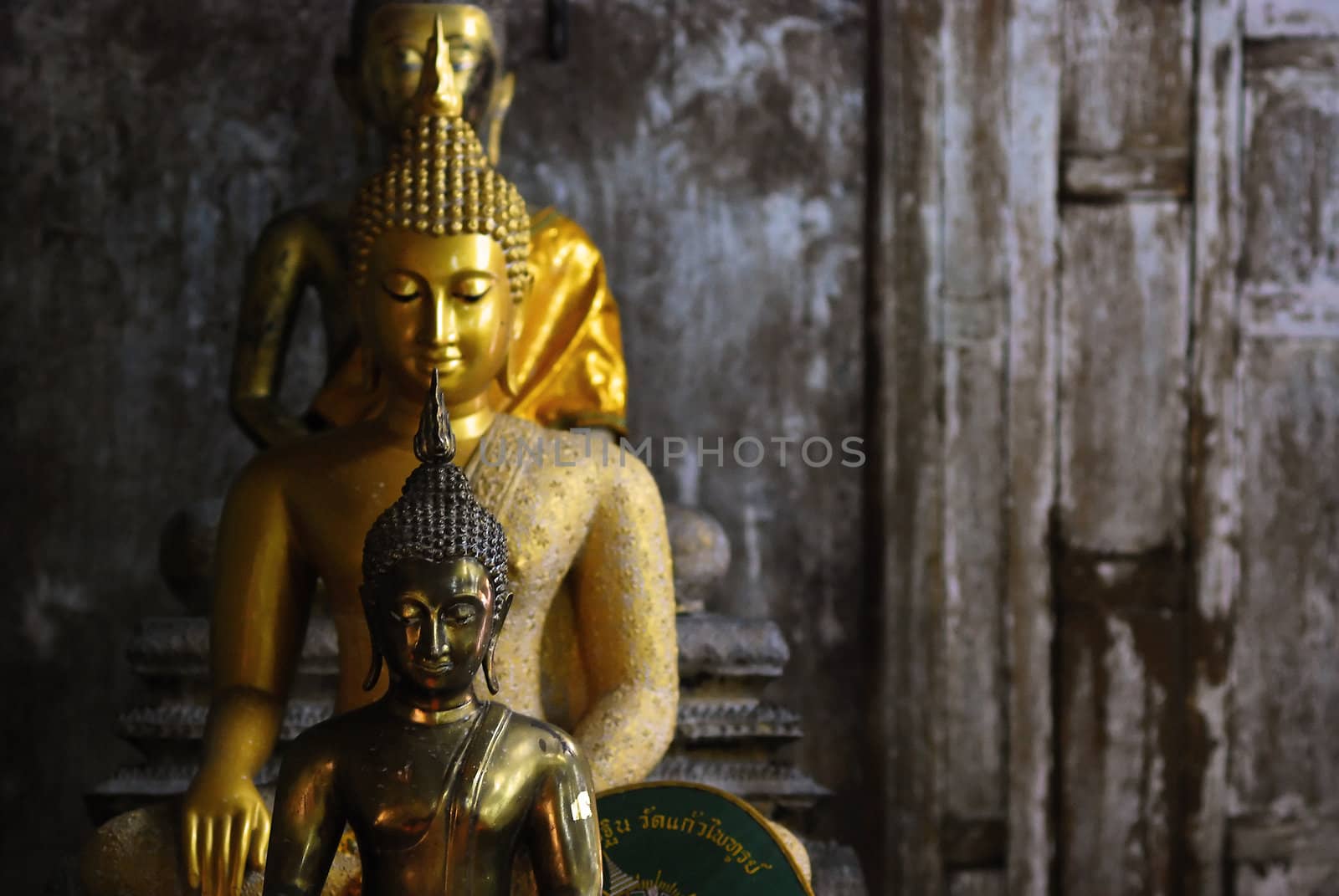 buddha sculpture with old wooden wall