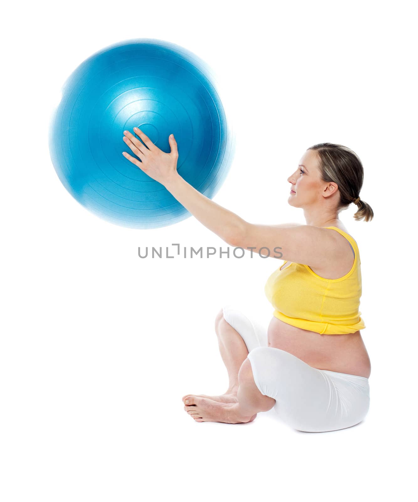 Attractive pregnant lady practicing yoga with gymnastic ball isolated over white