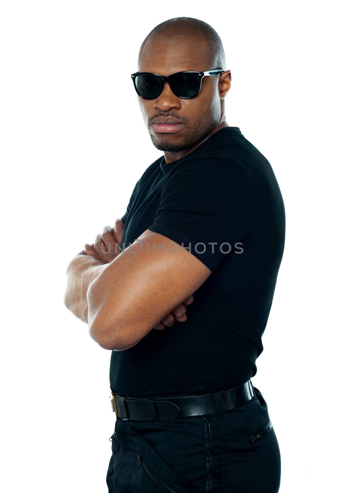 Portrait of secret agent standing with hands folded on white background