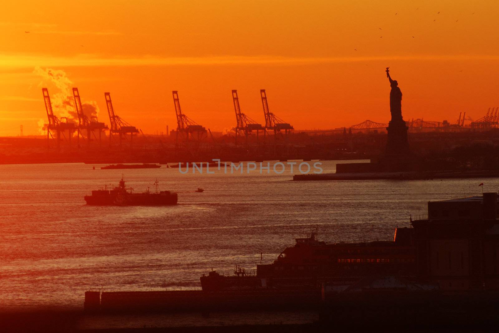 statue of liberty from new york during sunset