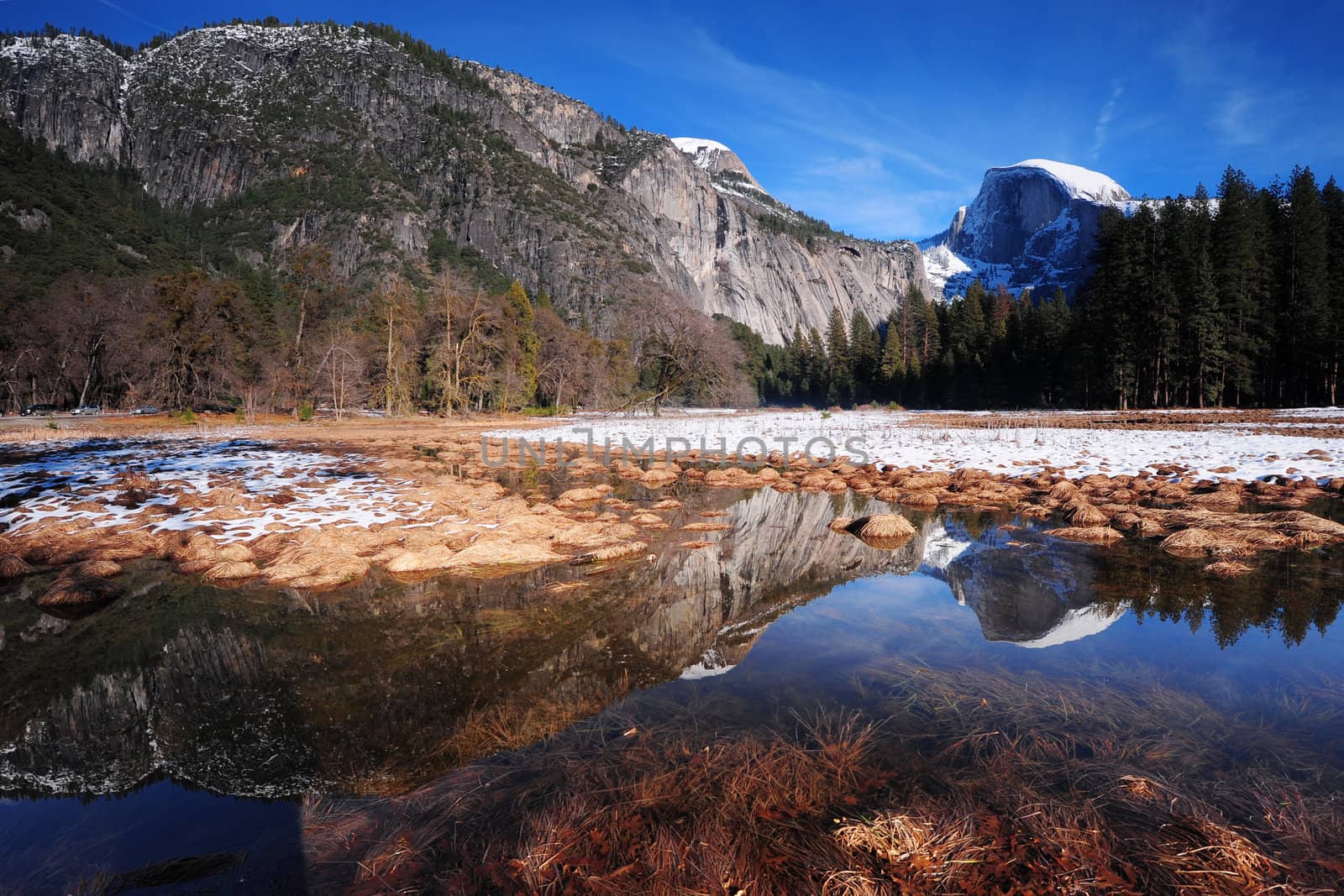 a half dome, yosemite in winter with reflection