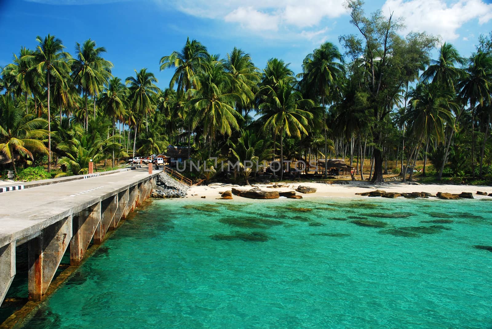 a bridge to island in Thailand with clear seawater