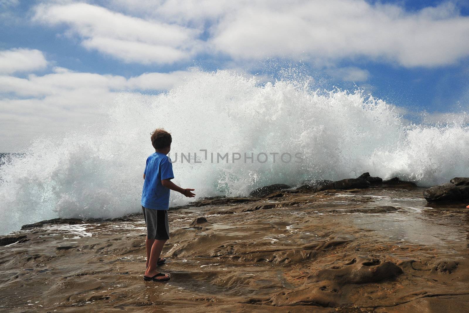 a kid was exciting to see wave splashed at La Jolla, California