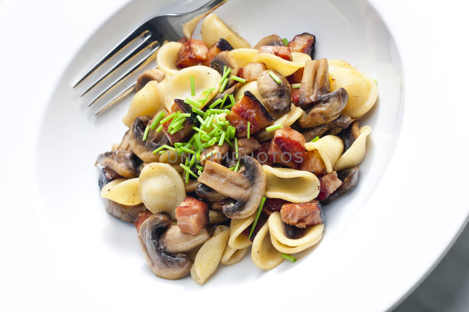 pasta orecchiette with fried champignons and bacon