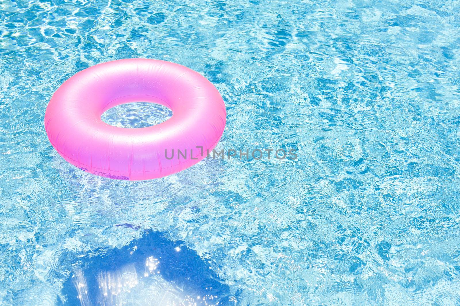 pink rubber ring in swimming pool by phbcz
