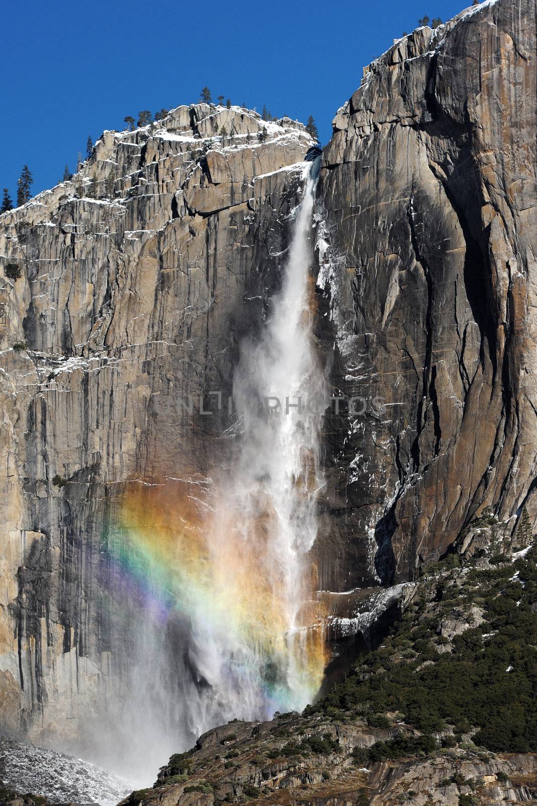 Waterfall with rainbow by porbital