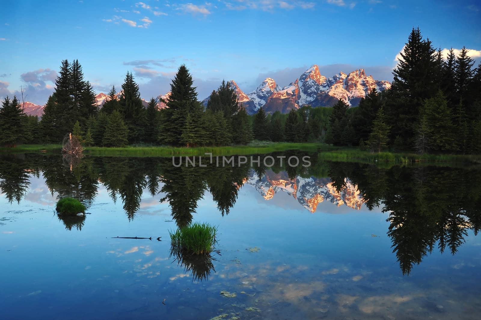 Grand Teton Mountains in Yellowstone with their reflections in the morning sunrise