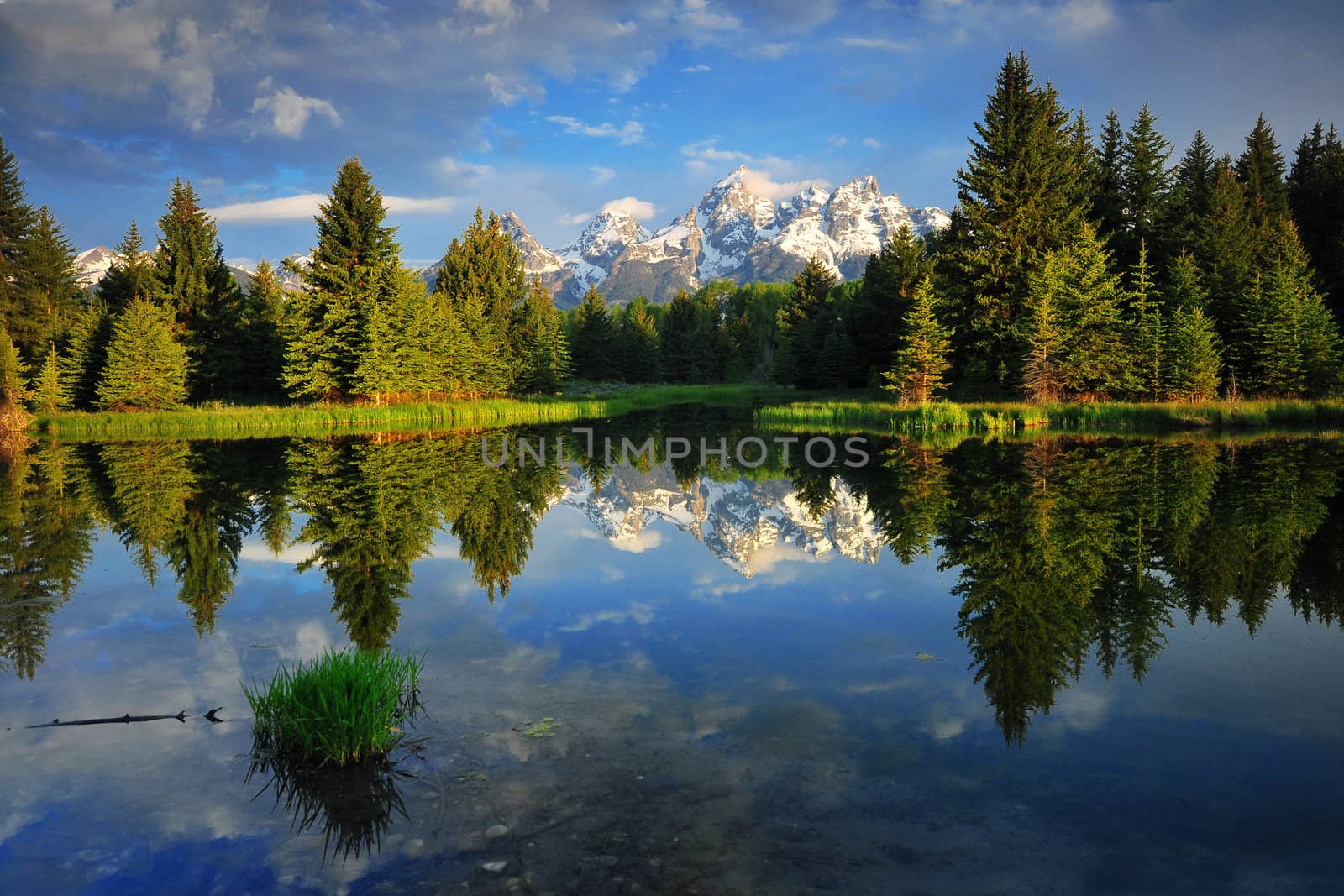 Reflection of Grand Teton Mountain with clouds in the morning