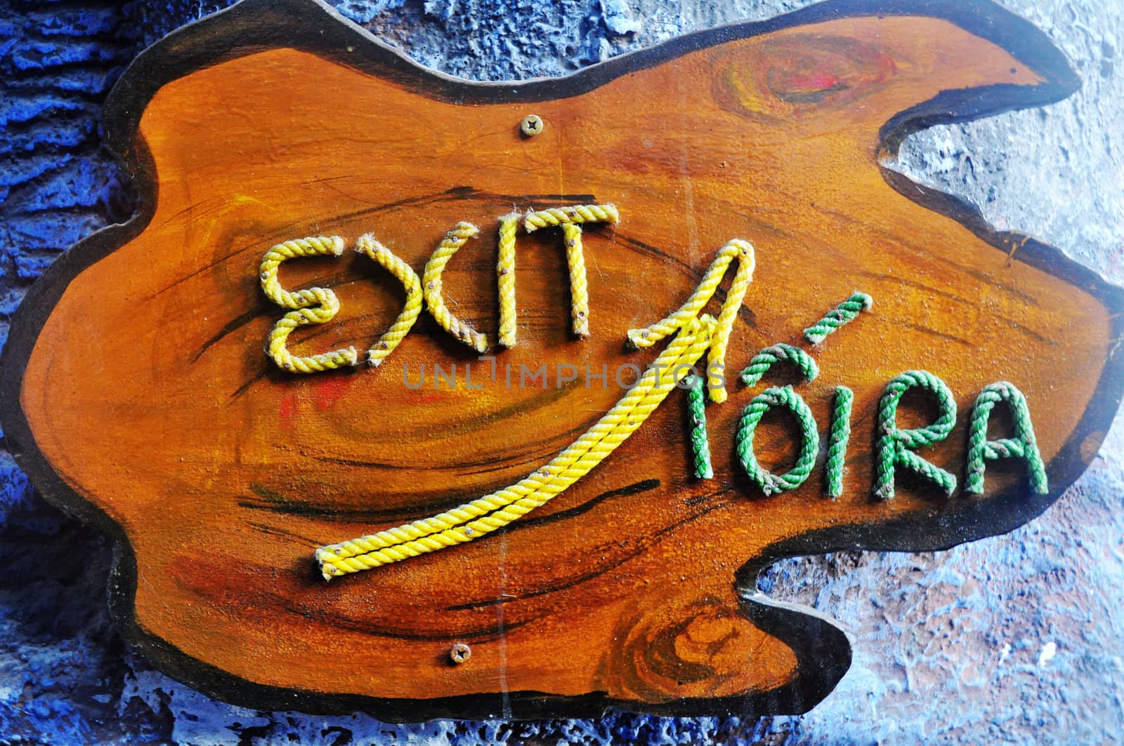 Exit sign made of rope on a piece of wood