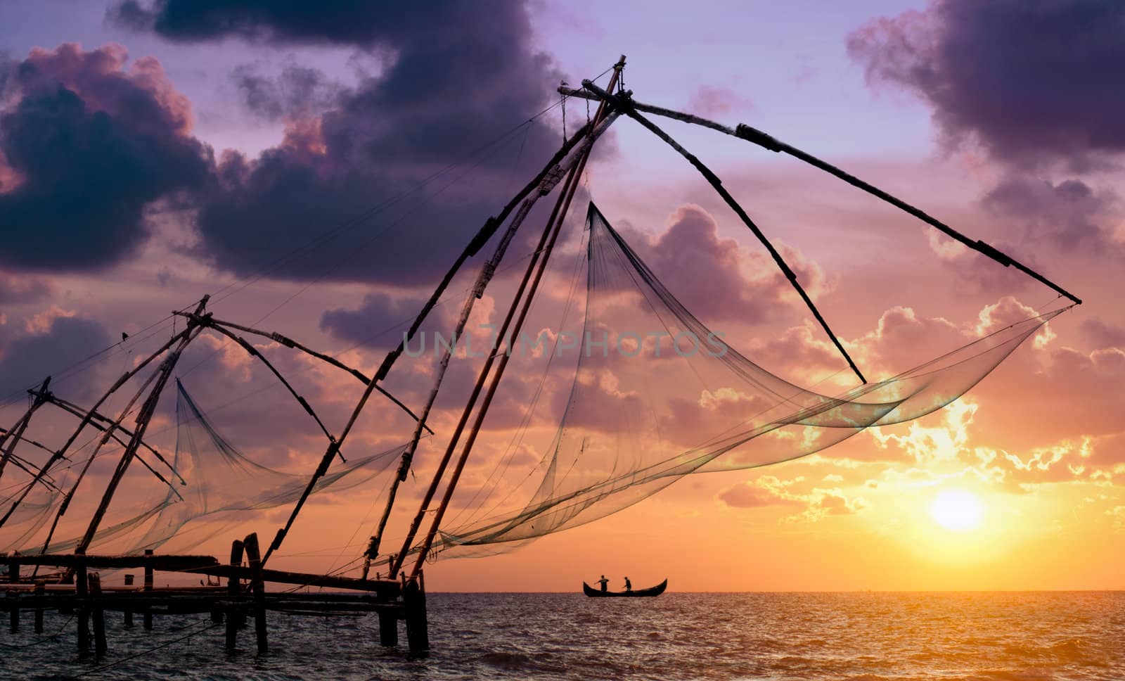 Sunset over Chinese Fishing nets in Cochin by johnnychaos