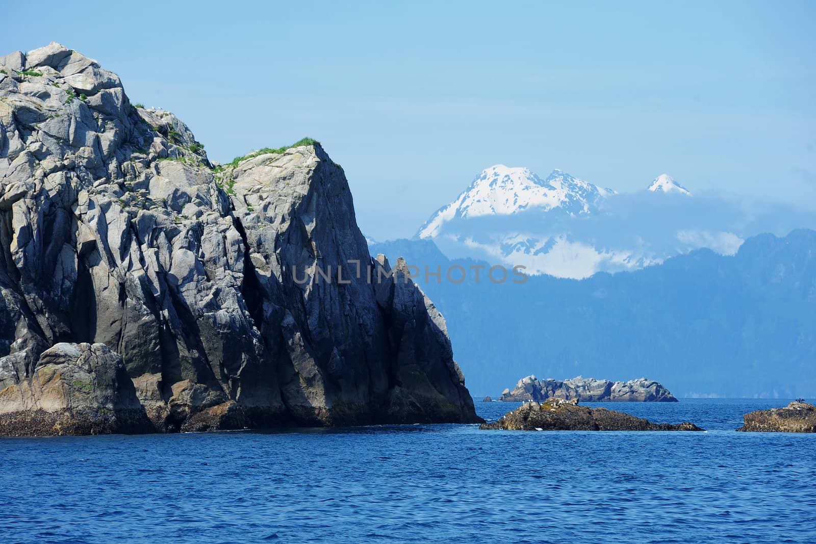 rock and mountain over ocean by porbital