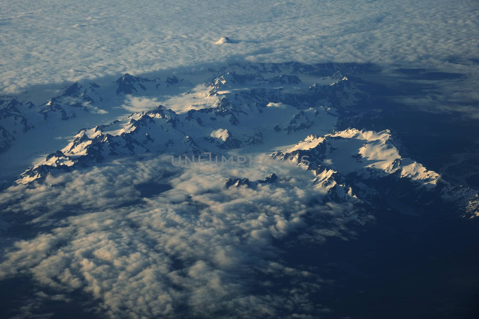 high mountain peaks in clouds from Alaska