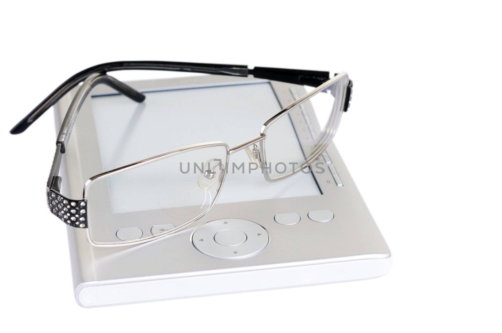 Reading concept with electronic book and glasses isolated on white background. Focus on the front of glasses