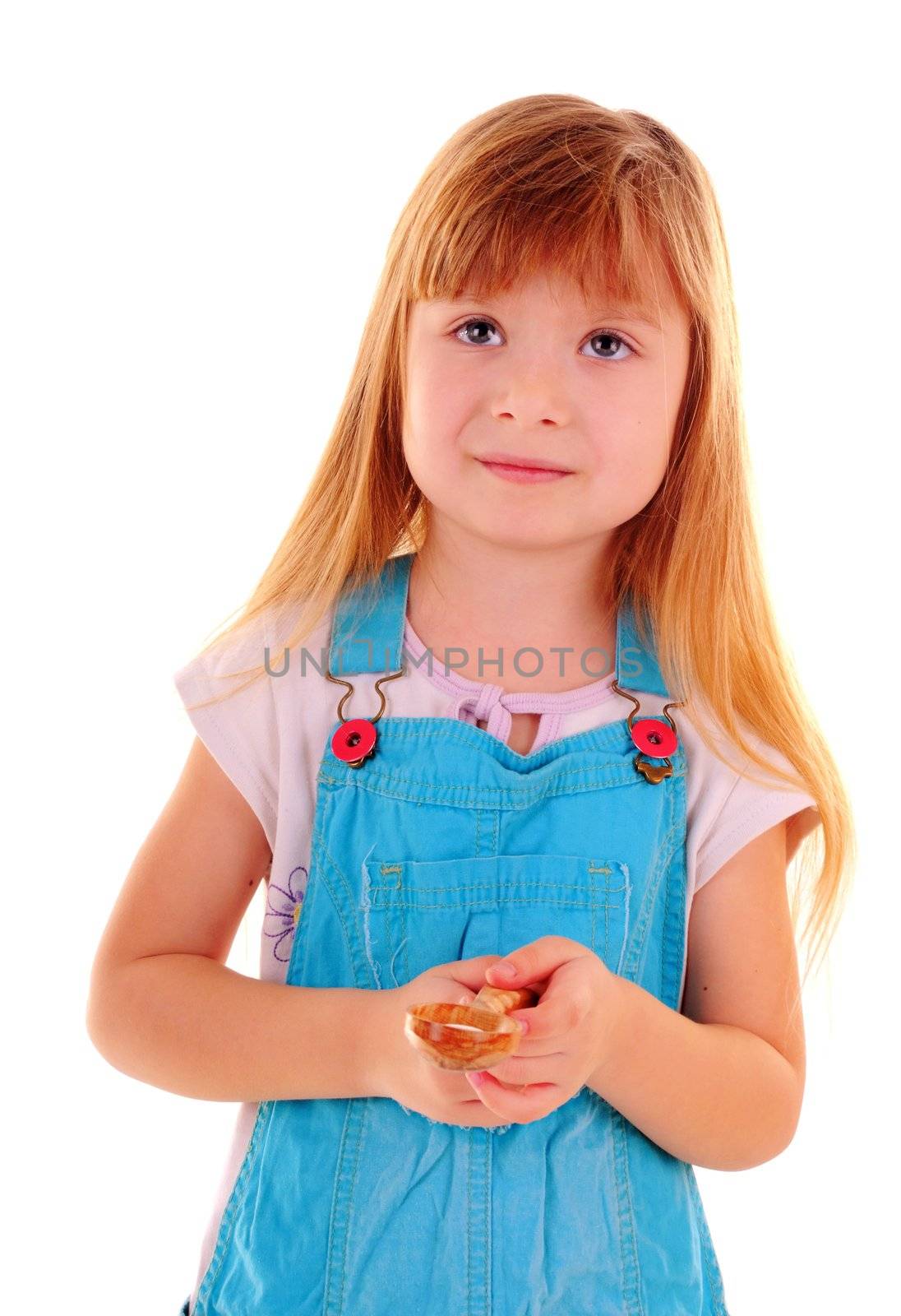 Small girl with spoon is looking up on white background