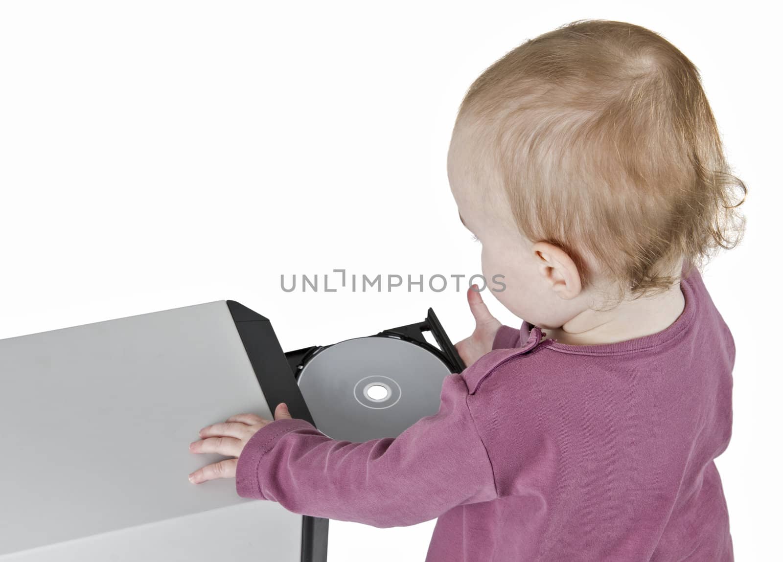 young child playing with CD and computer - isolated on white background