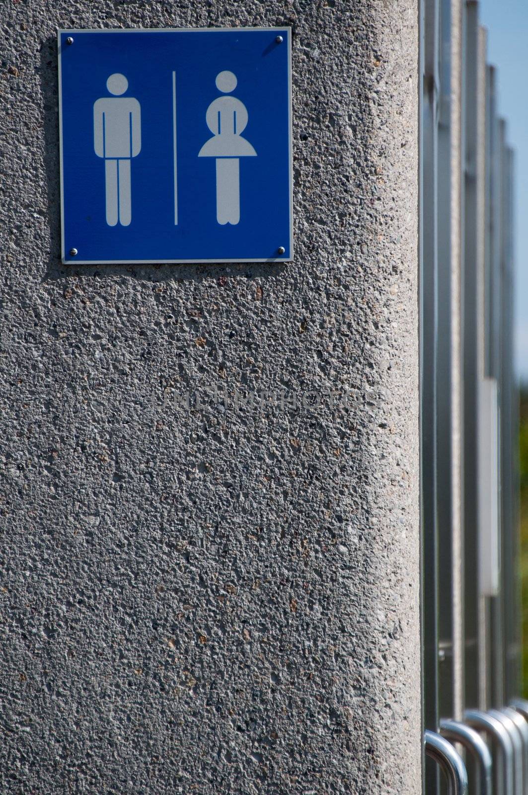 Modern unisex public toilets - sign with doors in a row