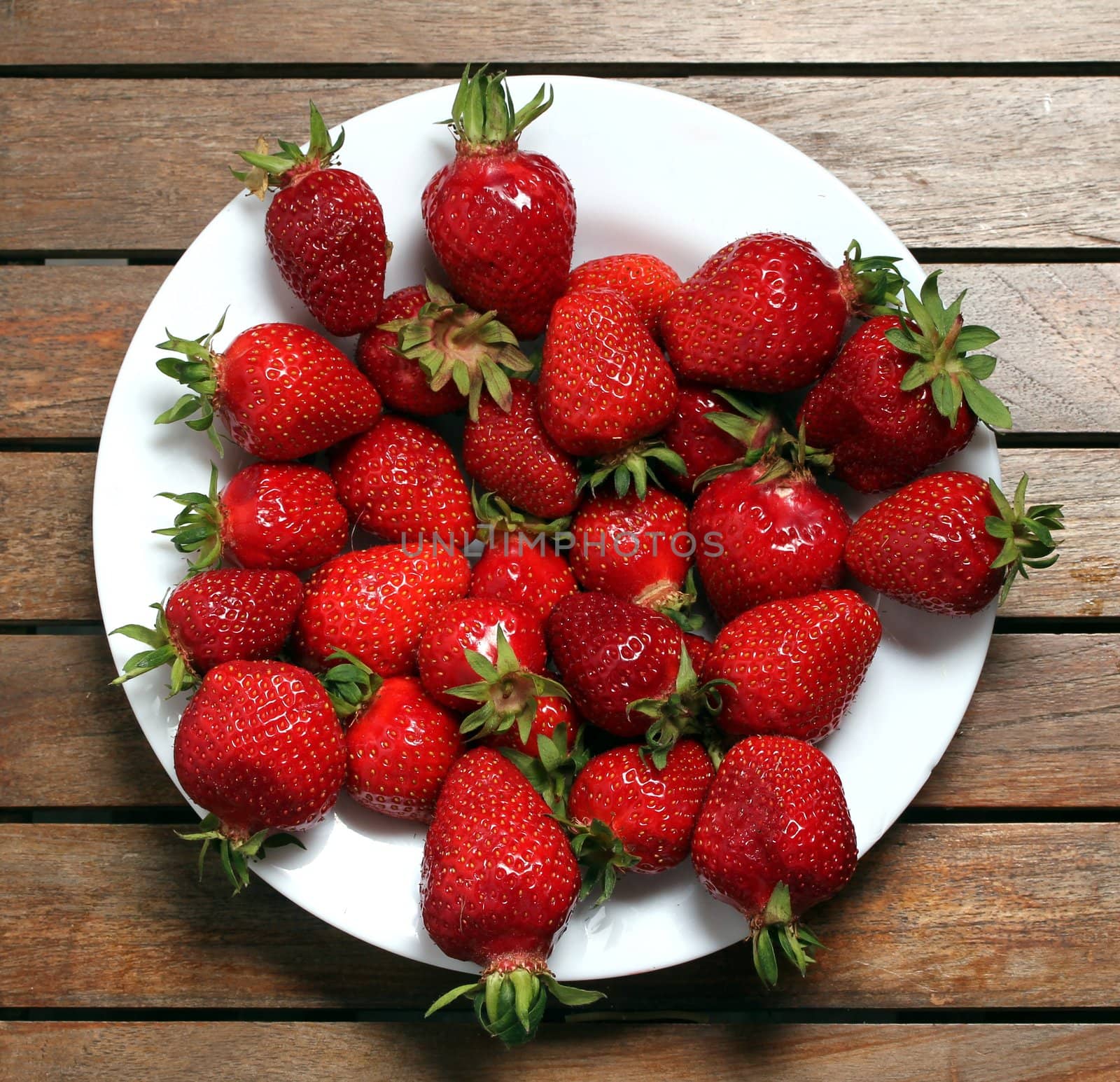 a plate of fresh strawberries