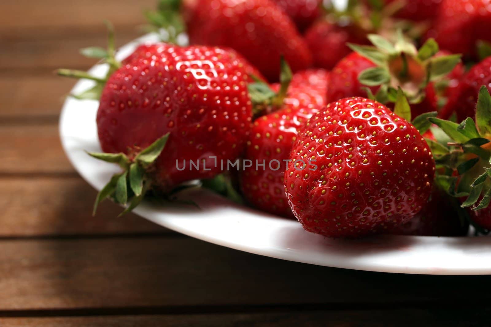a plate of fresh strawberries