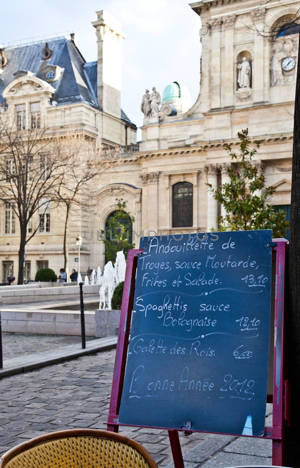 Black board with a menu restaurant in a tipical traditional square in Paris