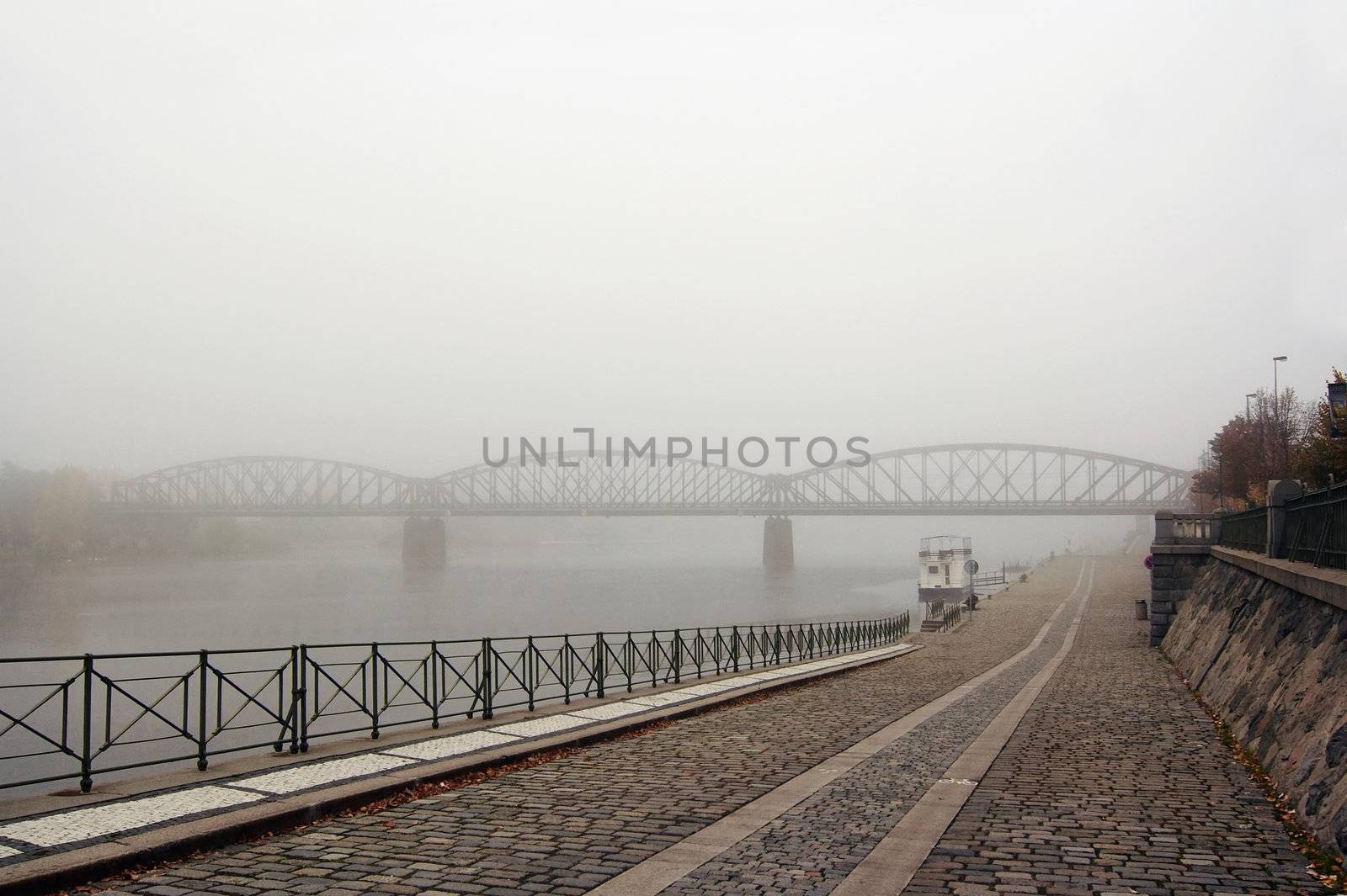 Prague railway bridge in early morning fog