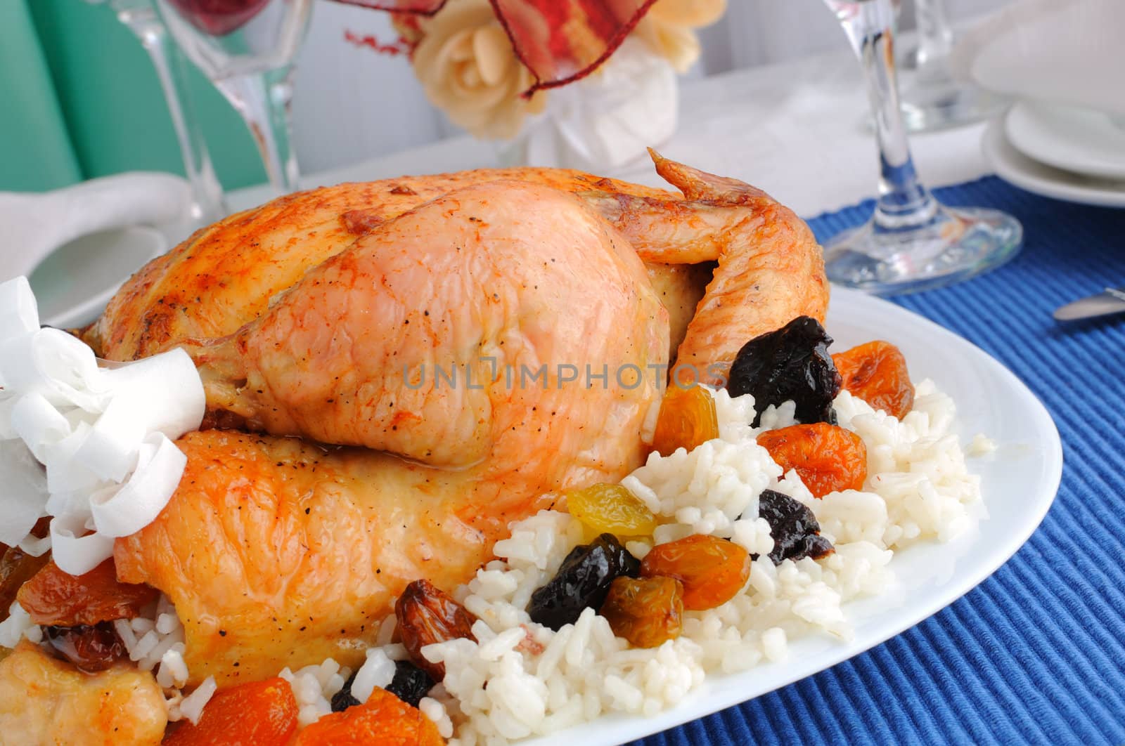 Grilled chicken with rice and dried fruits closeup