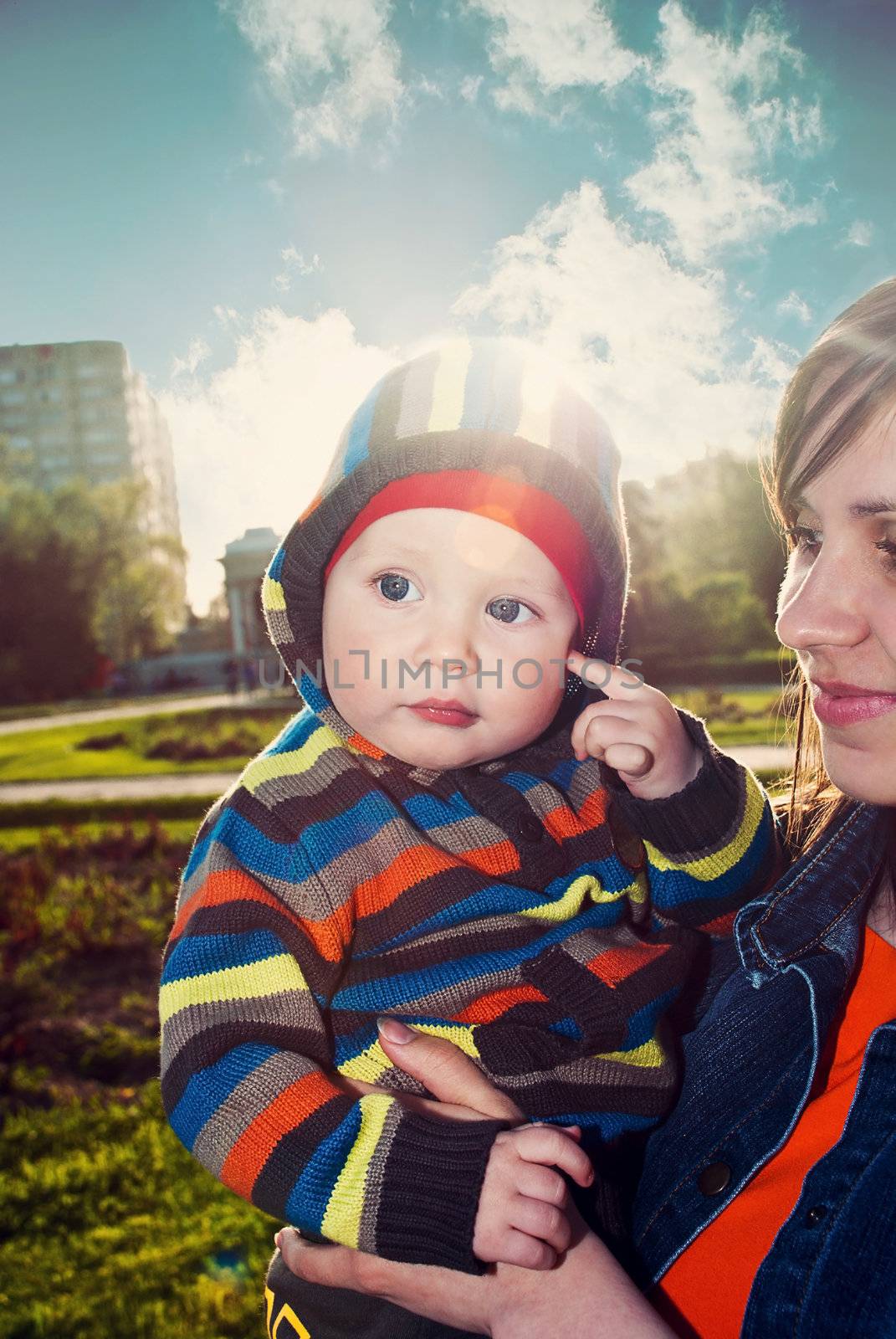 Happy mother with son in spring park.