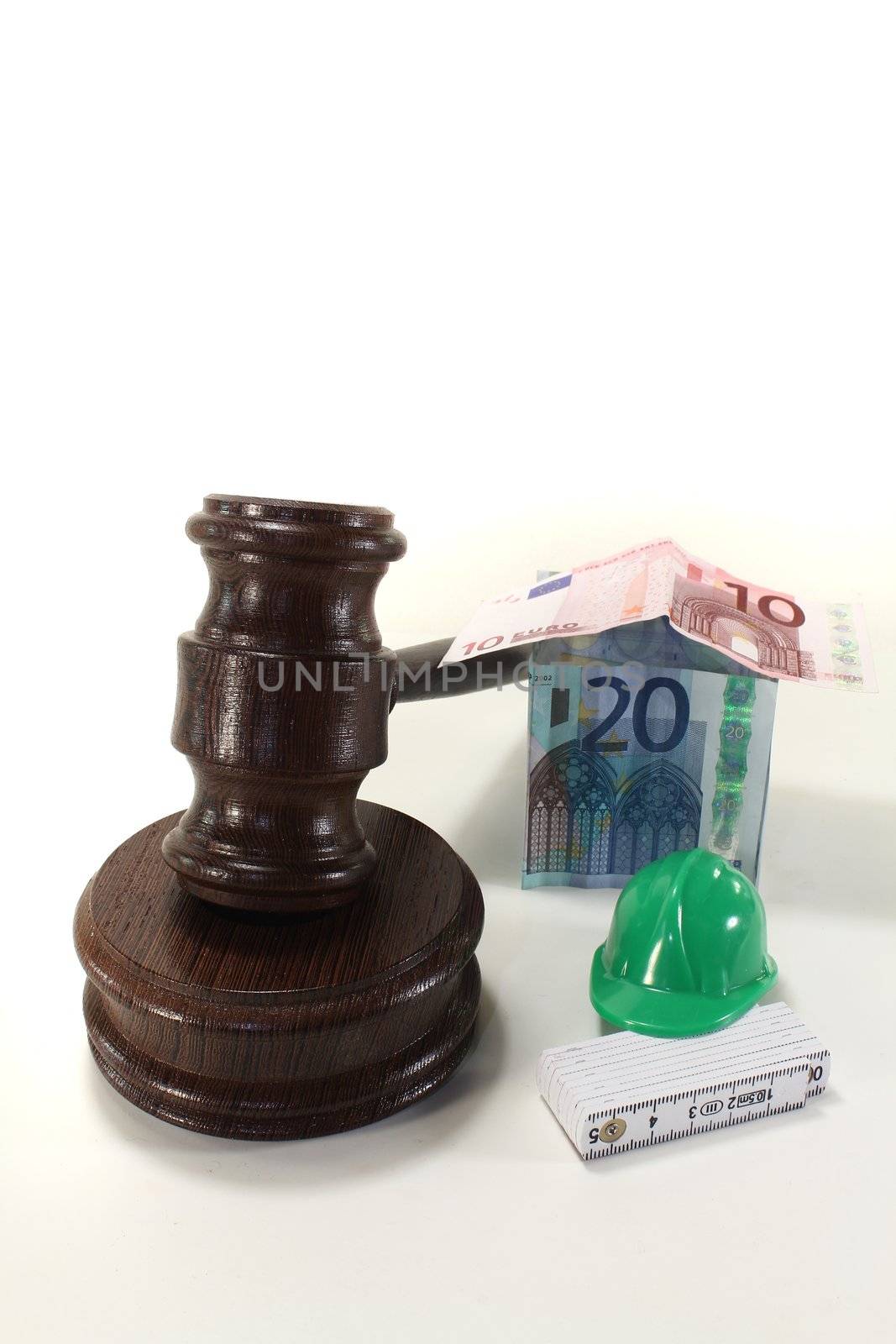 Labour - Gavel with Euro house, construction helmet and ruler on a light background