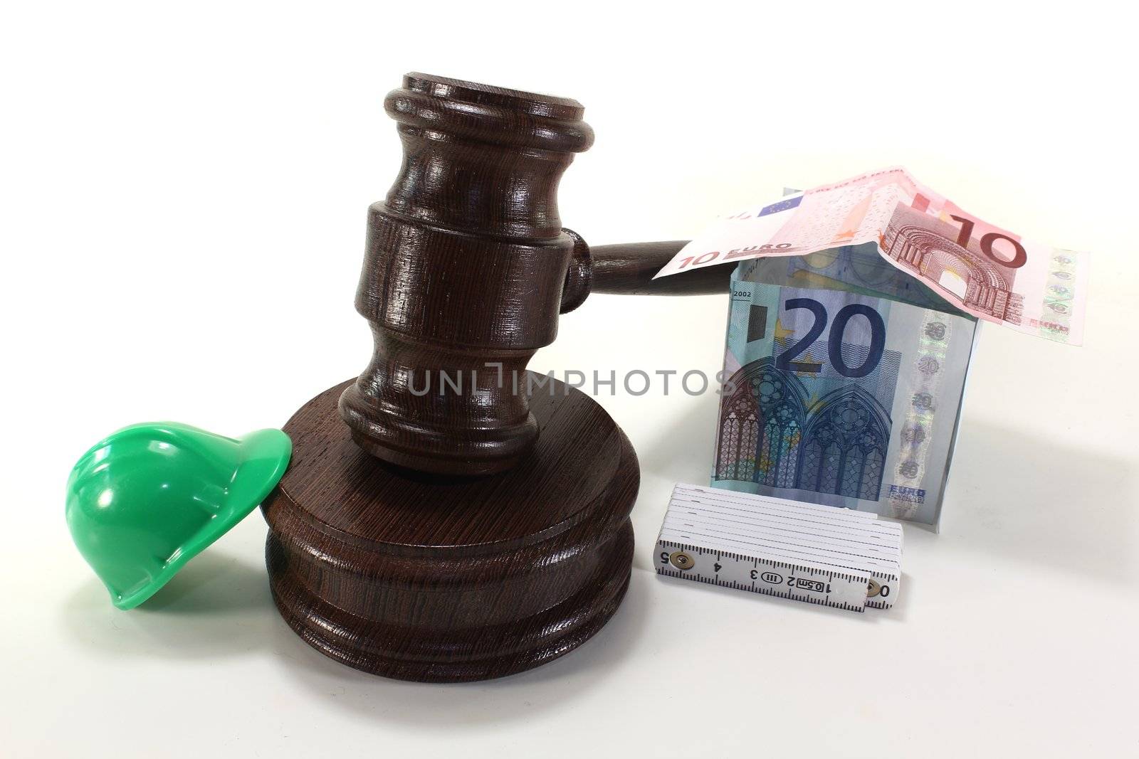 Labour law - Gavel with Euro house , construction helmet and rule