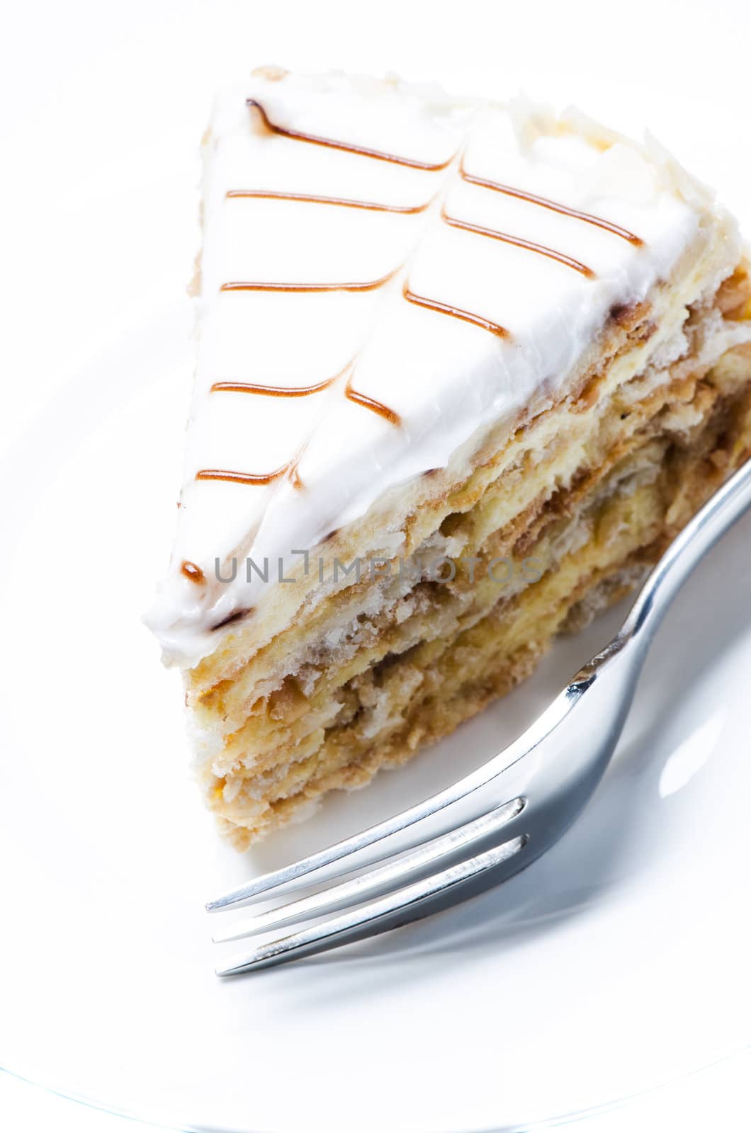 Slice of almond cake close up by Nanisimova