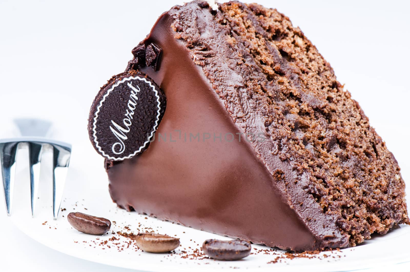 Piece of chocolate cake on white by Nanisimova