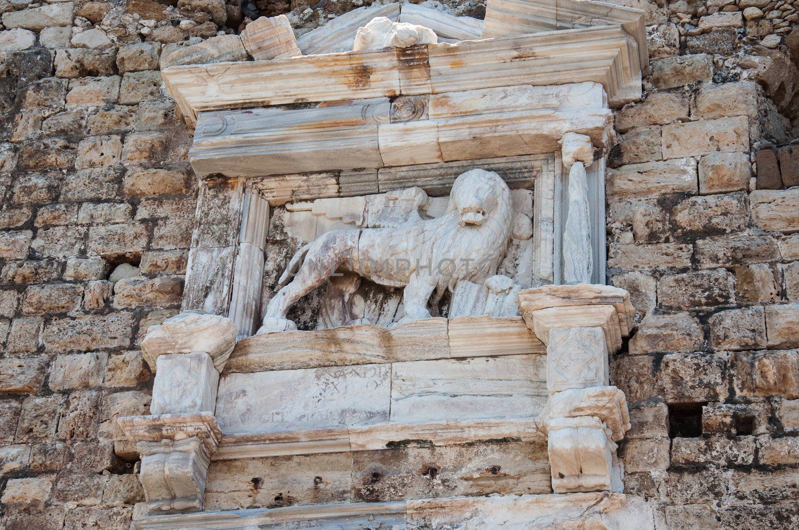 Ancient rock wall with lion sculpture in Chania, Crete