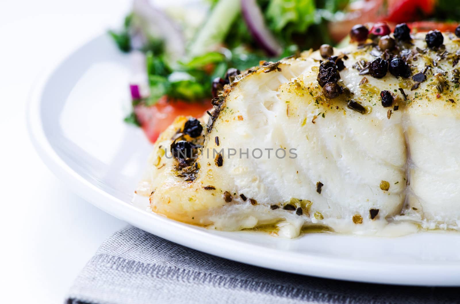 Grilled fish with salad close up