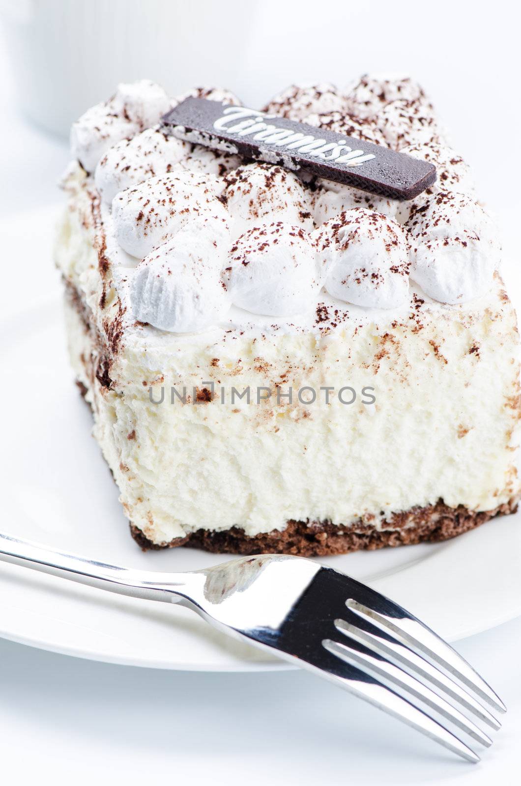 Tiramisu cake on white saucer