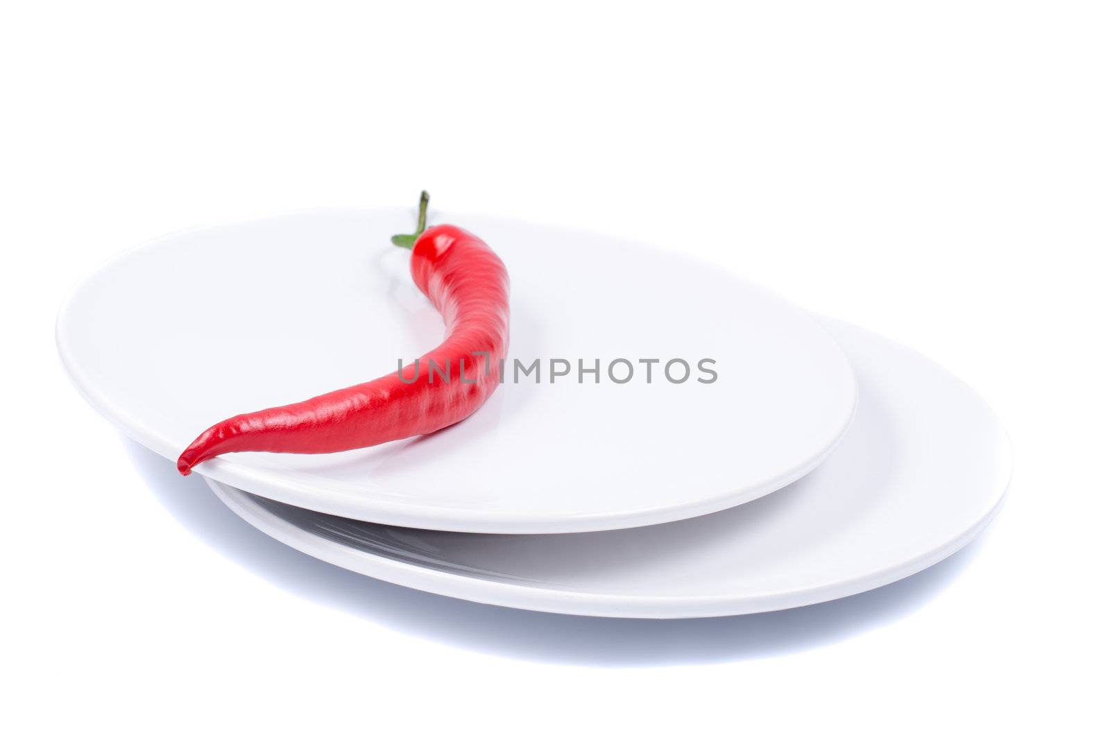 Red chili pepper on plate isolated close up