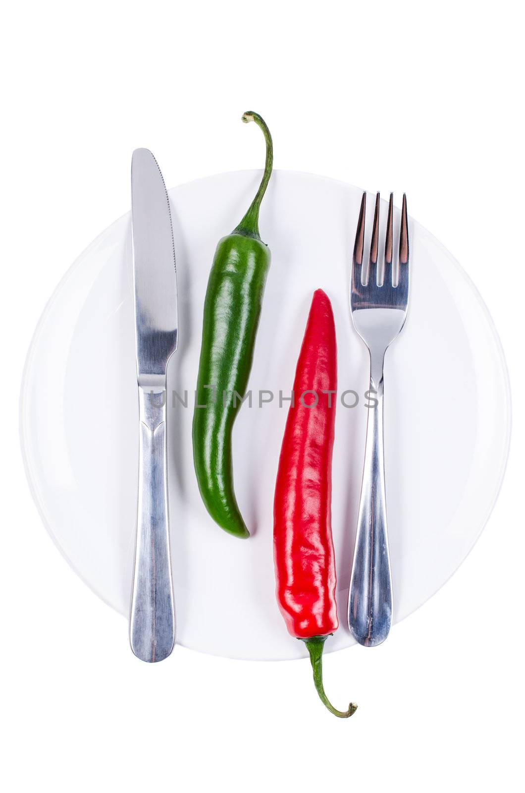 Red and green chili peppers on plate by Nanisimova