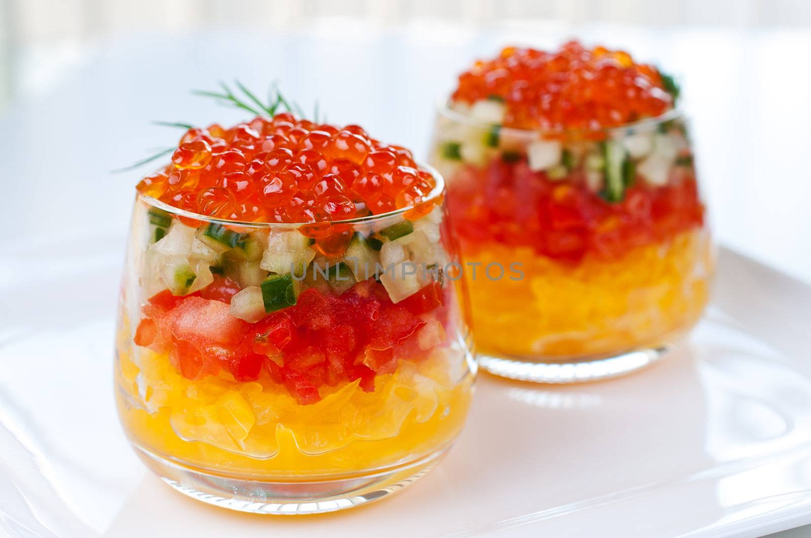 Caviar with vegetable  in glasses close up by Nanisimova