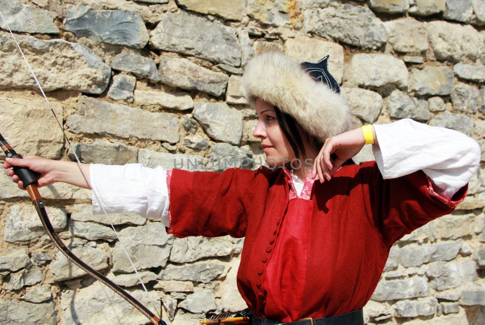 Beautiful young girl with bow and arrows. Close up