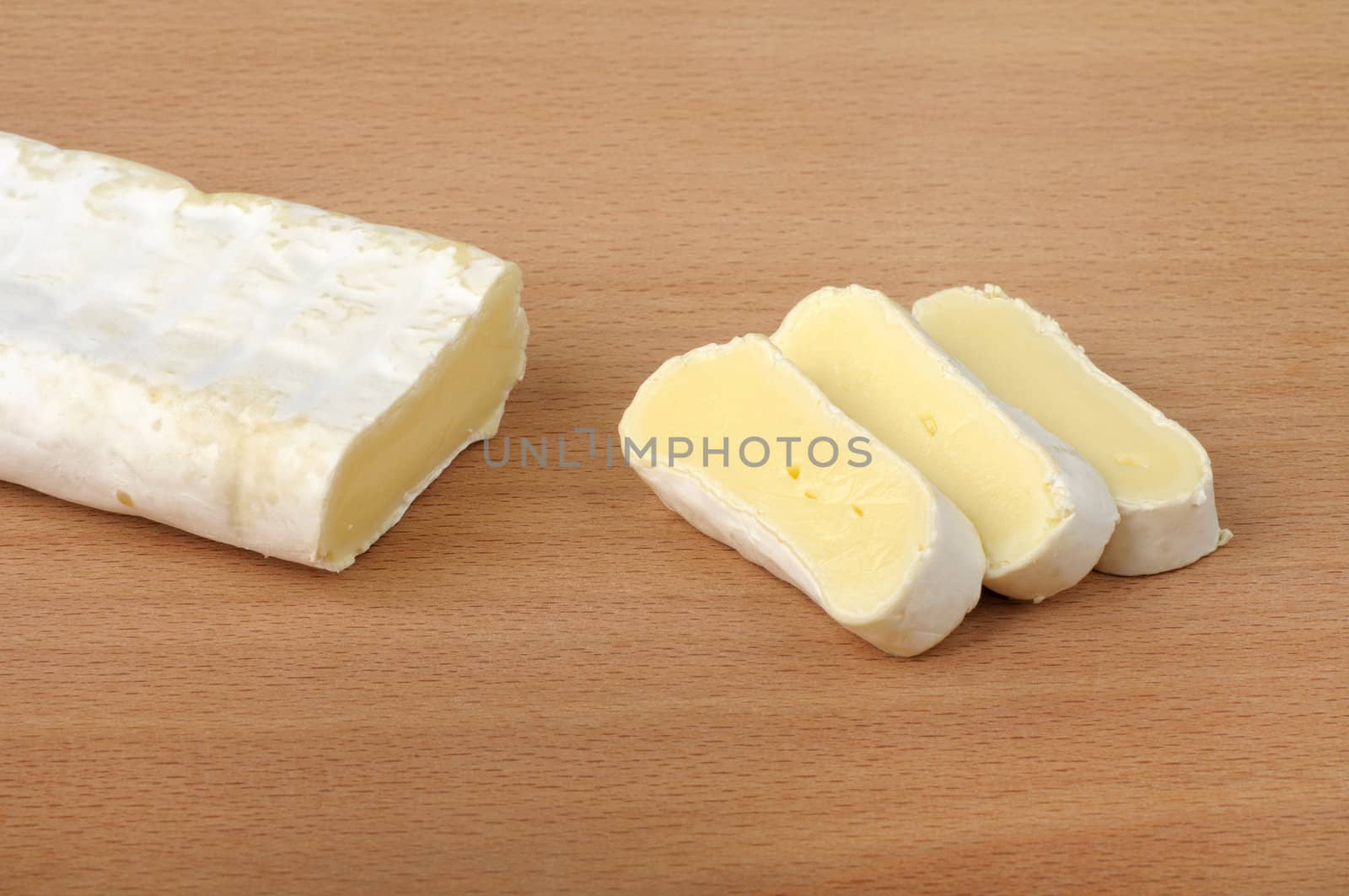 sliced ??brie cheese on a wooden background