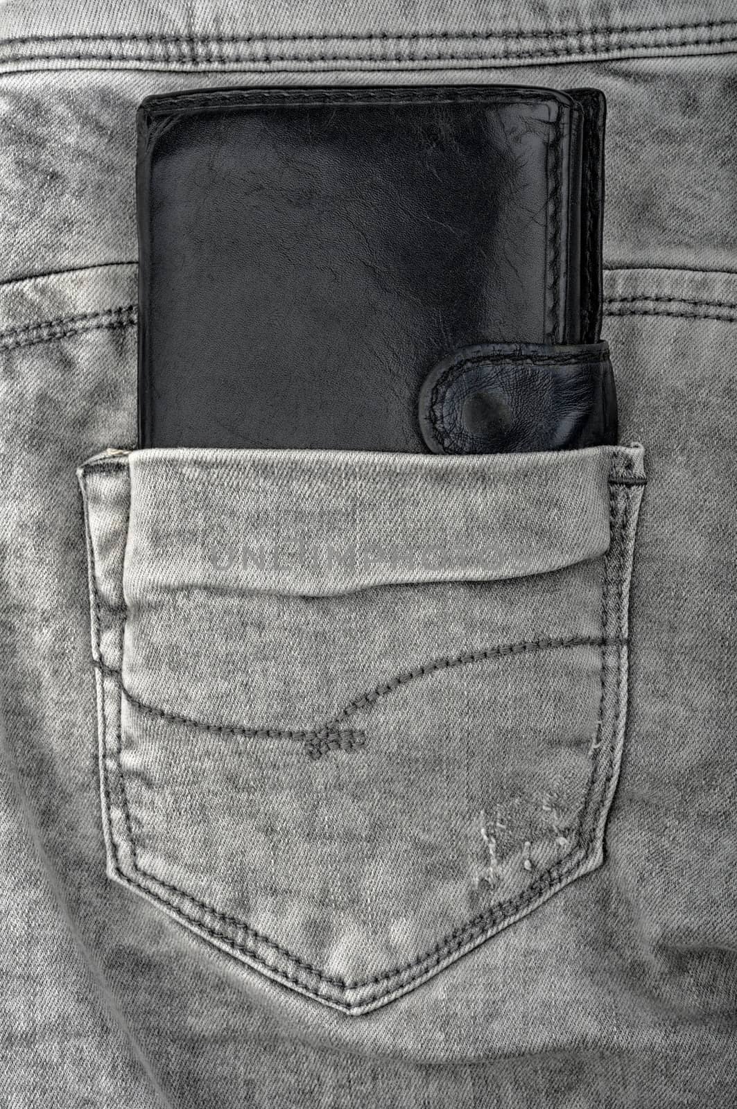 old leather wallet in the old gray jeans