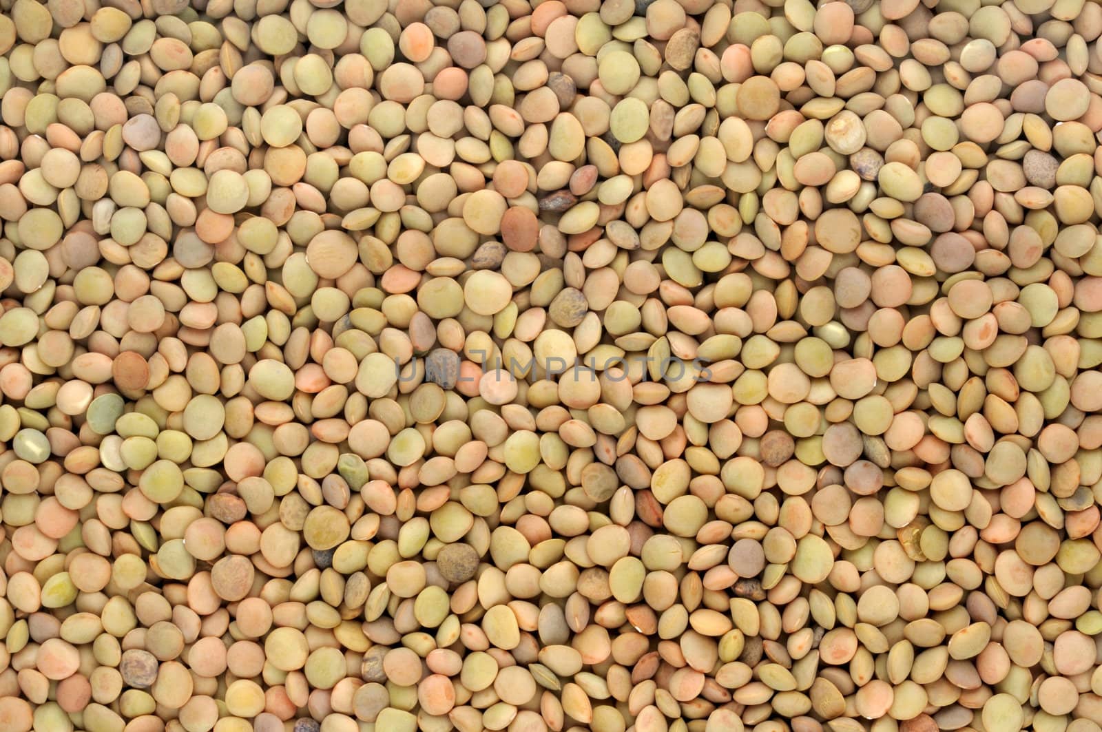 background of brown small dry raw lentils