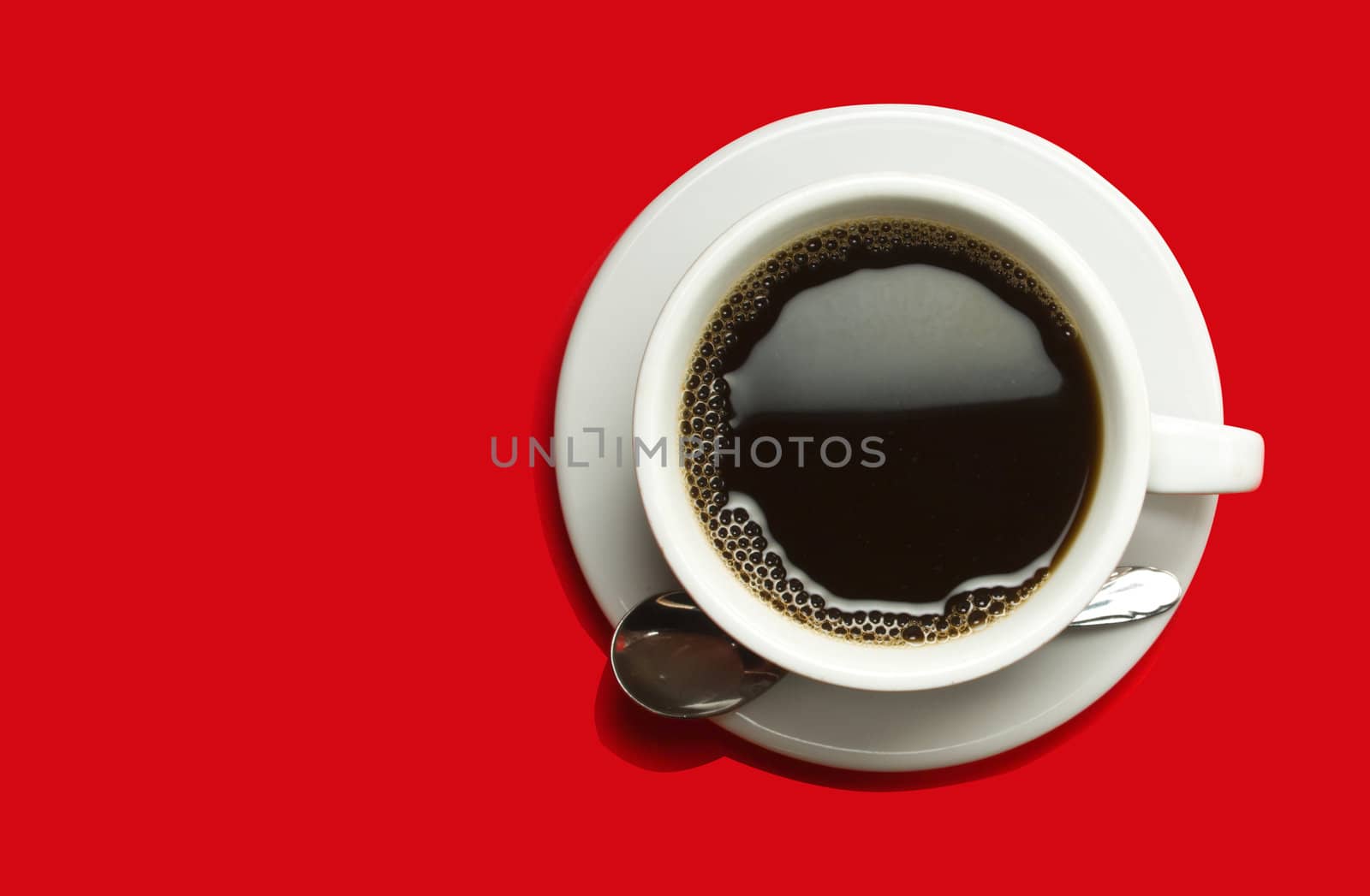Picture of black coffee in a white cup on a red background