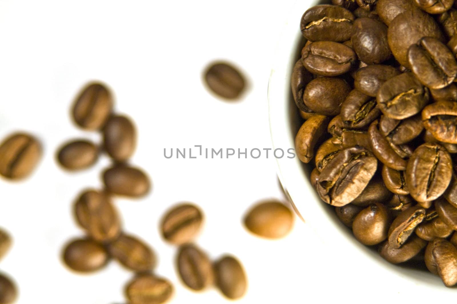 The cup of coffee and beans, small depth of sharpness.