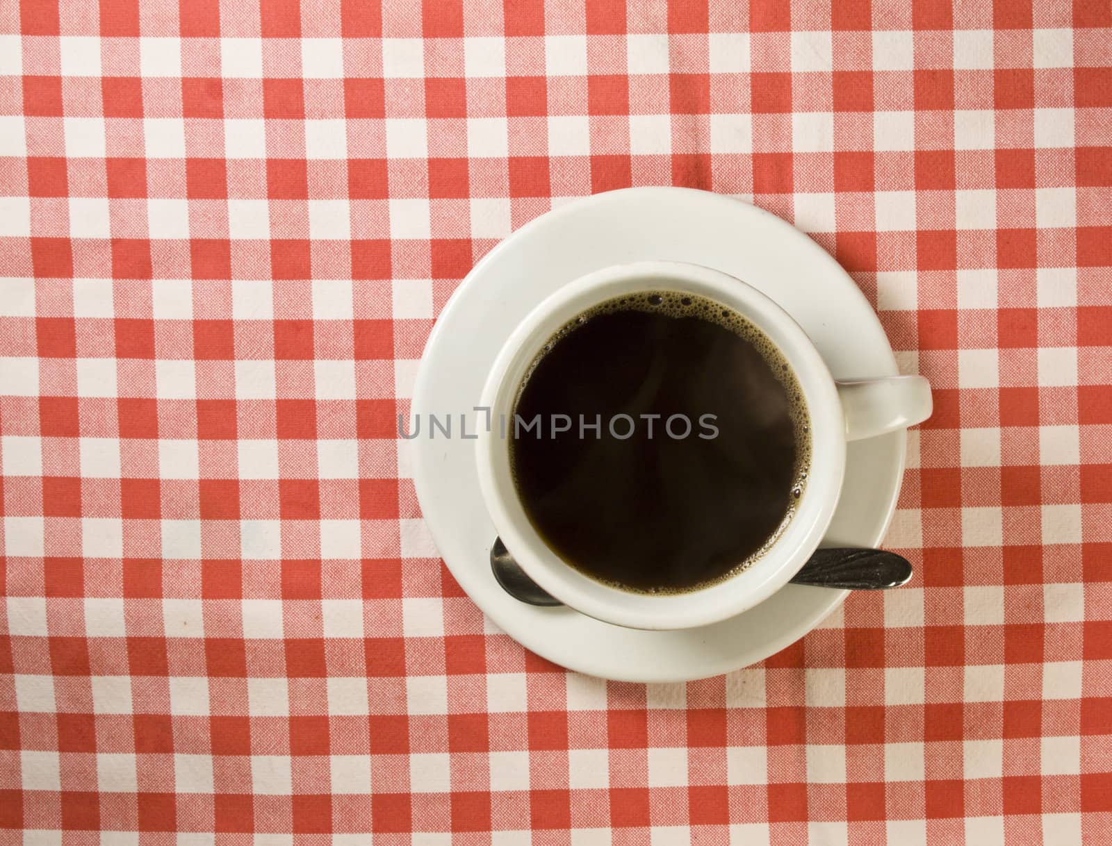 Fresh coffee on a red-white fabric cloth
