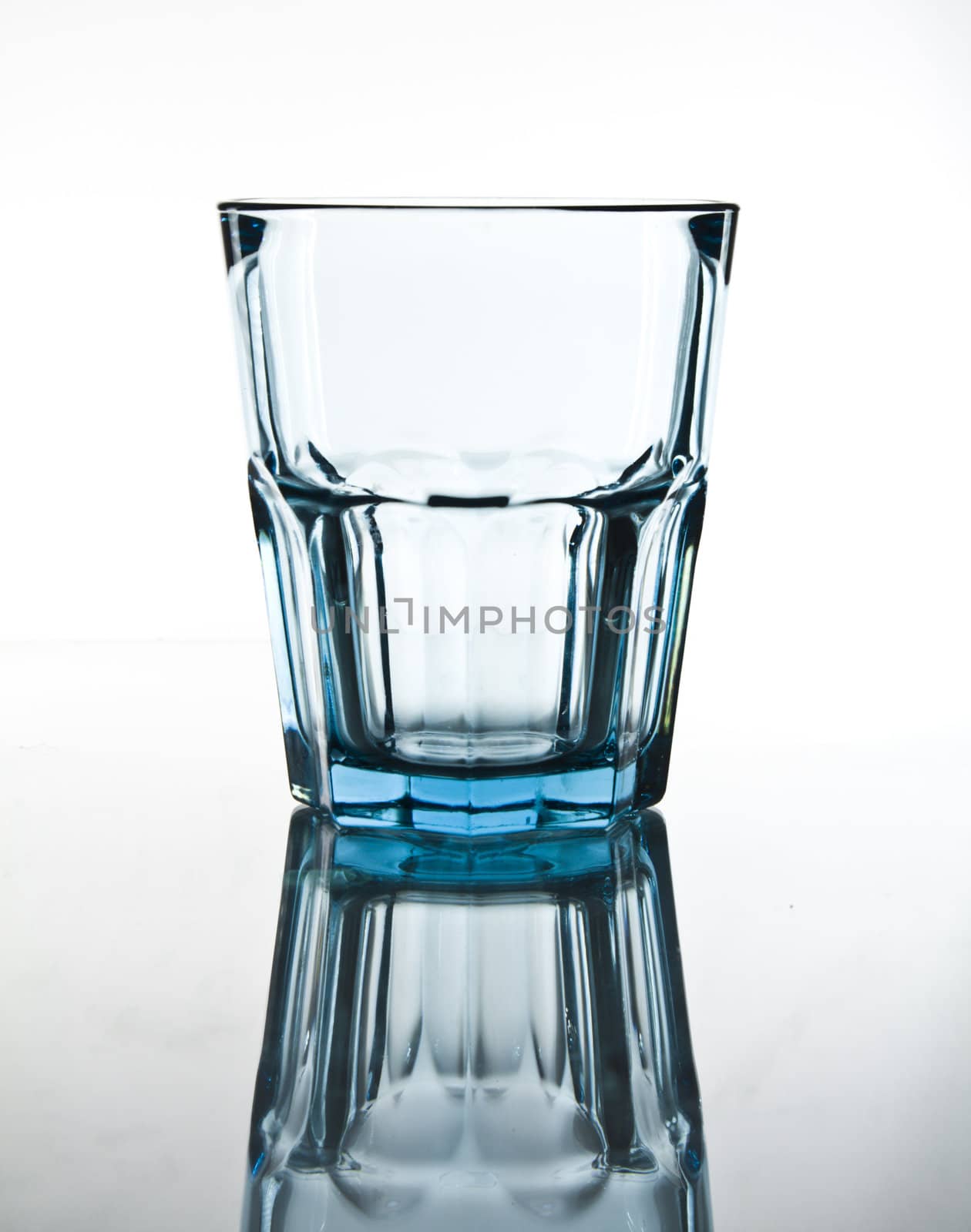 blue glass on white background with reflection