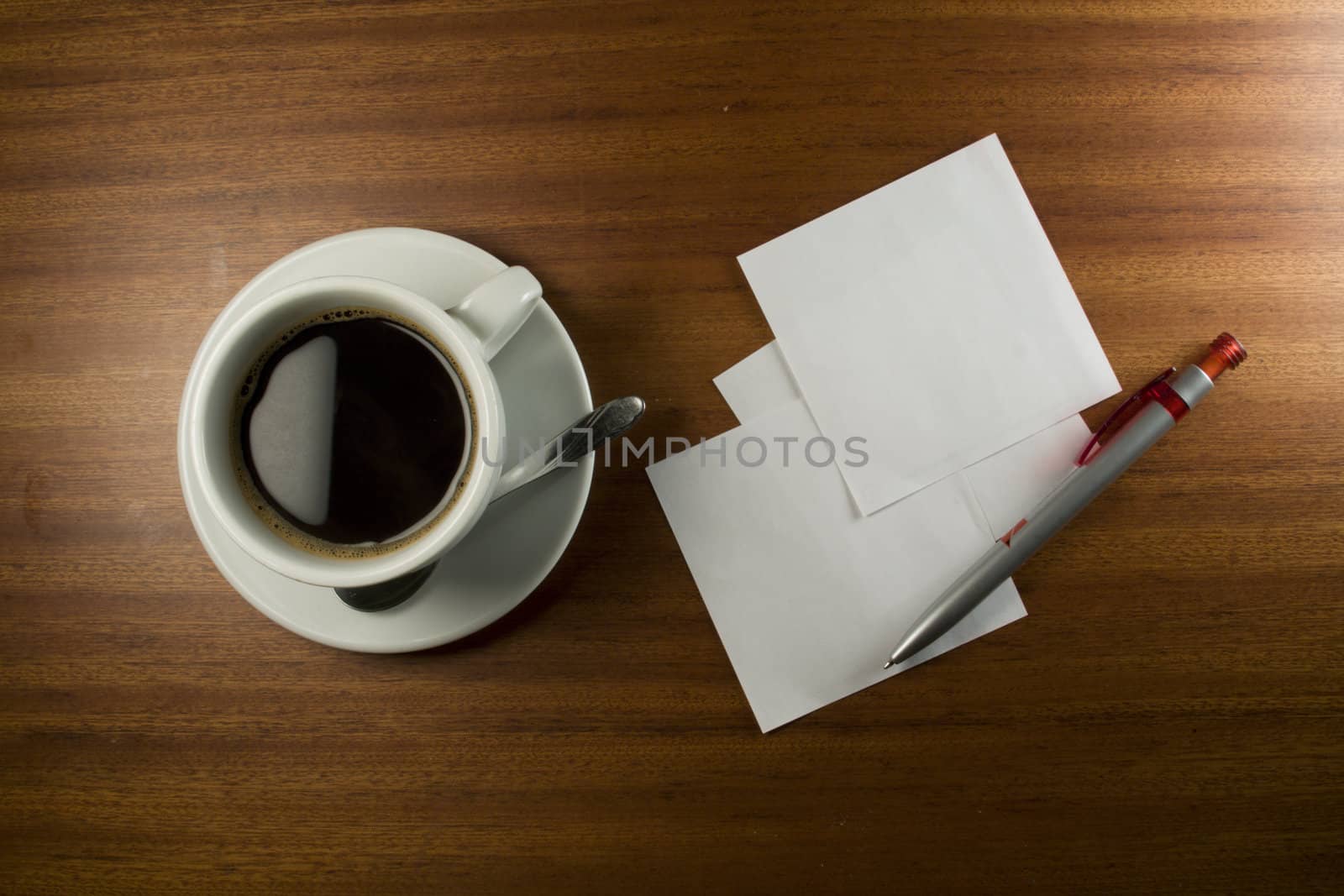 Note Card, Pen and Coffee Cup on Wood Background.