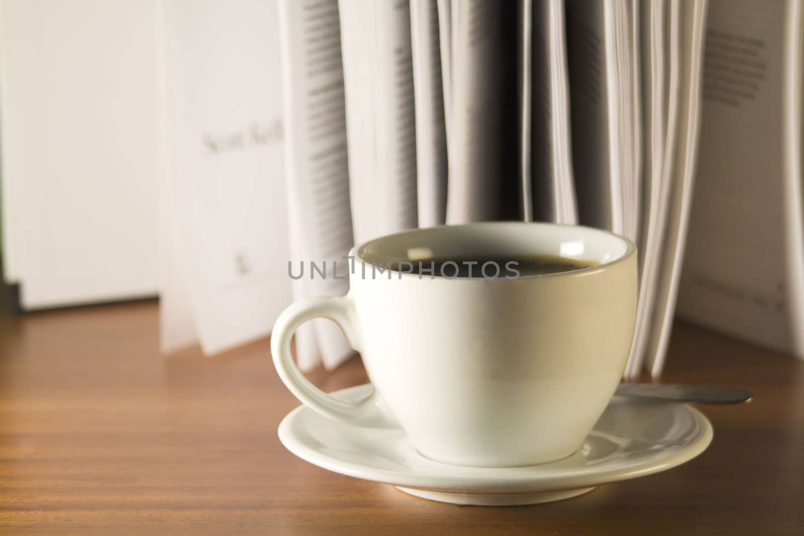 Coffee and books on a wooden table. Small depth of sharpness.